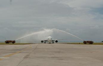 The crew and passengers are given a water cannon salute as the plane taxies towards the terminal buildings