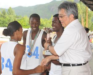 Representatives of the Praslin Secondary School accept the secondary category cup from Minister Shamlaye 