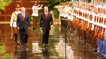 President Michel inspects a guard of honour. On the left is President Castro