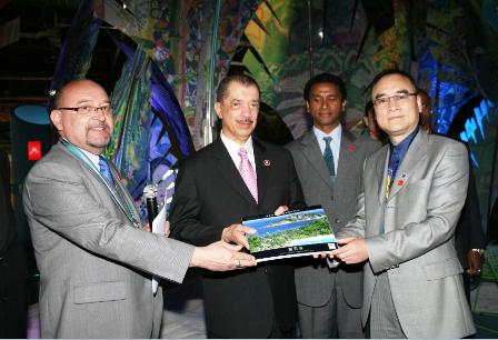 Handover of Chinese version of Seychelles Leisure and Business guide by Ambassador Le Gall (left) and businessman Xu Weiping (right) to President Michel