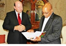 Mr St Ange looks on as Mr Zuma views the carnival’s booklet