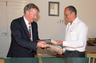 Sir John (left) and Dr Payet exchange documents after signing the memorandum of understanding