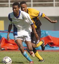 St Louis Youth's goalscorer Henriette is chased by Sunshine Youth's captain Yannick Charlette