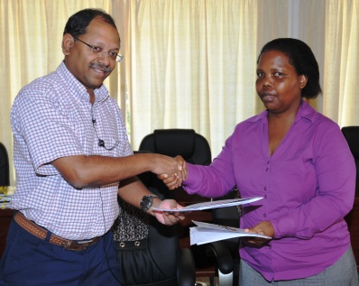 Mr Afif and Ms Dlamini exchange documents after intialing the DTA