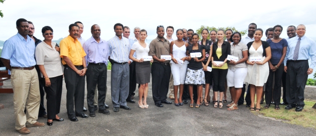 The students in a souvenir photograph with guests after they were presented with their travel documents