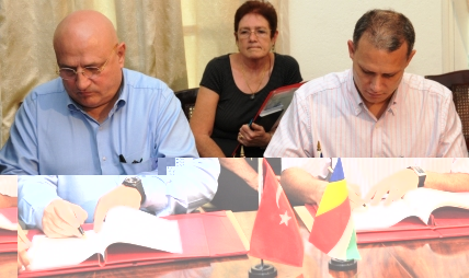 Mr Adam (right) and Mr Kayalar signing the visa waiver agreement yesterday