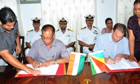 Minster Adam (right) and Mr Darlong signing the MoU