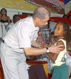 The winners celebrate, Praslin Secondary (left) and Anse Aux Pins Primary (right), President Michel presents his Fair Play Cup to a representative of Anse Aux Pins Primary (leblow left)