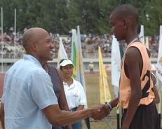 Fredericks congratulates a gold medal winner from Takamaka