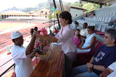 Minister Pool is presented with a bouquet of flowers