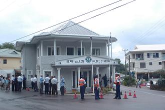 Commissioner Waye-Hive cuts the tape (inset) to officially open the newly renovated Beau Vallon police station 