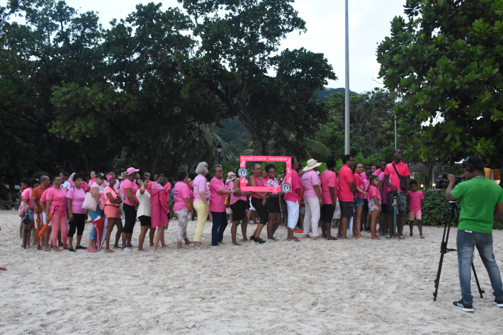 Large crowd brace bad weather for annual cancer beach walk   